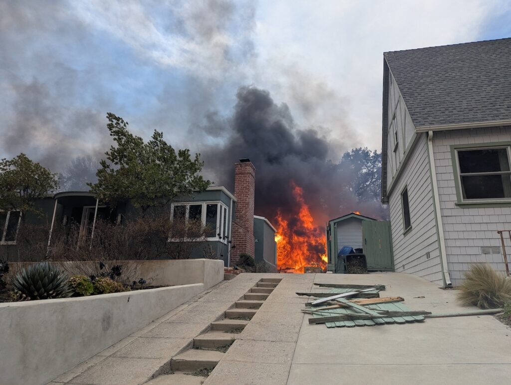 Photo of a home burning in LA County. Photo courtesy of Timithie Norman